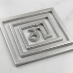 Close-up of Beej Mantra engraving on lead helix Vastu remedy for south-west corner